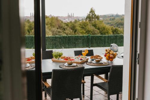 a table with food on top of a balcony at La Casa del Camino in Santiago de Compostela
