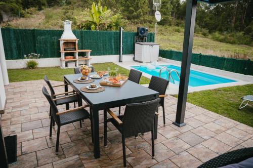 a patio with a table and chairs and a pool at La Casa del Camino in Santiago de Compostela
