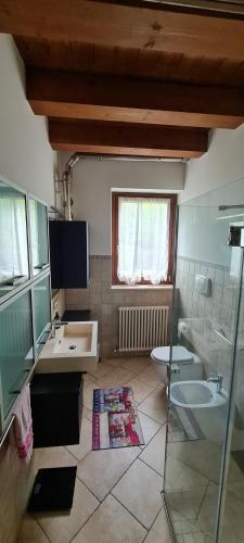 a bathroom with a sink and a toilet at Casolare 1898 in Pesaro