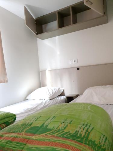 deux lits côte à côte dans une pièce dans l'établissement Bungalow charmant à Saint-Jean-du-Gard avec piscine partagée, à Saint-Jean-du-Gard