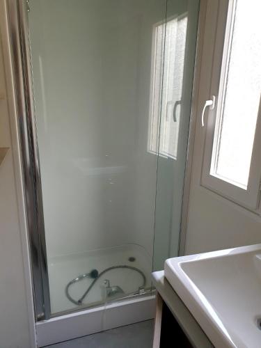 une salle de bain avec douche et lavabo dans l'établissement Bungalow charmant à Saint-Jean-du-Gard avec piscine partagée, à Saint-Jean-du-Gard