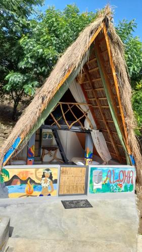 a hut with a thatched roof on a beach at Dream Ville in Ella
