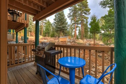 a screened porch with a grill and a table and chairs at Alpine Alcove: Tahoe Tranquility Near Kings Beach in Tahoe Vista