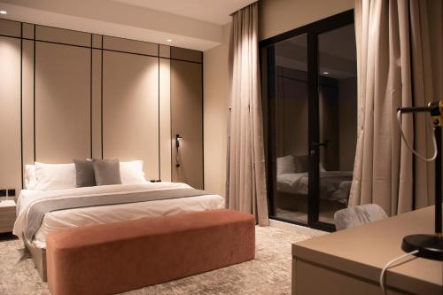 a bedroom with a king sized bed and a desk at جراند ريجس للشقق الفندقية in Riyadh