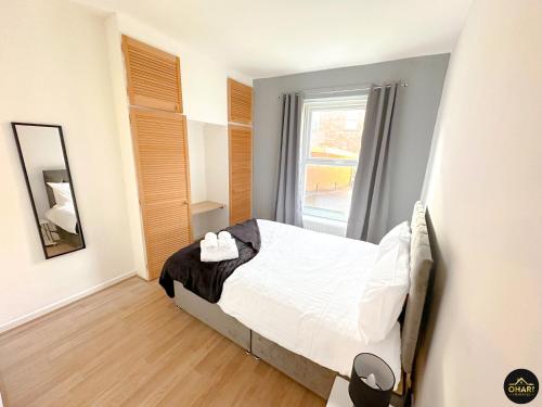 a bedroom with a bed and a window at Modern 1 Bed Apartment In Morpeth Town Centre in Morpeth