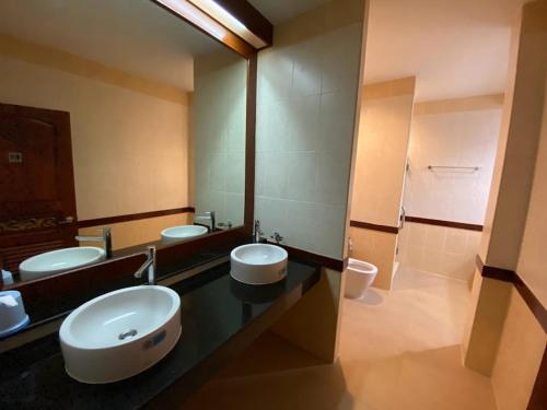 a bathroom with three sinks and a toilet at Phuket Private Pool and Thai Villa Style by Andaman Home in Phuket Town