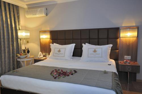 a bedroom with a large bed with flowers on it at Grand Atakum Hotel in Samsun
