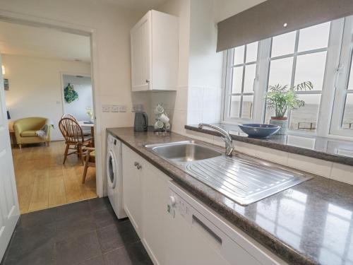 a kitchen with a sink and a counter top at Hen Felin Isaf in Llanddona