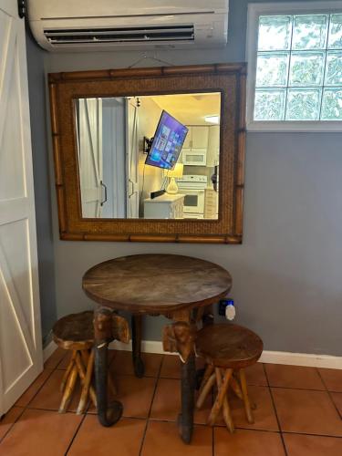 a table and stool in front of a mirror at Cottage in Stock Island in Key West