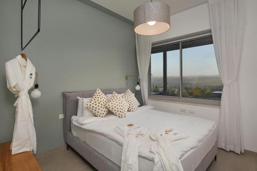 a bedroom with a bed with a large window at THE ALTA GALILEA - 2BRM WITH POOl/Amazing view/Gakuzi in Mishmār Hāyardin