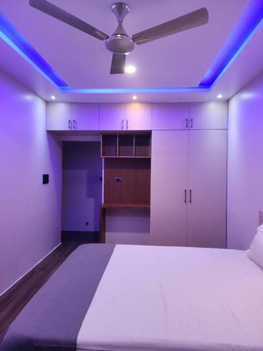 a bedroom with a bed with purple lights on it at MYKA SD ZANITA HEIGHTS in Vasco Da Gama