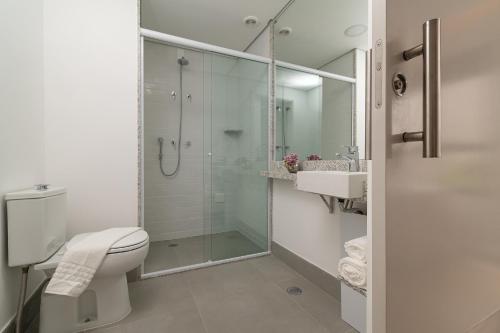 a bathroom with a shower and a toilet and a sink at EZ Moema Hotel in São Paulo