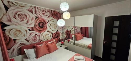 a bedroom with a wall mural of roses at Dorian Apart in Constanţa
