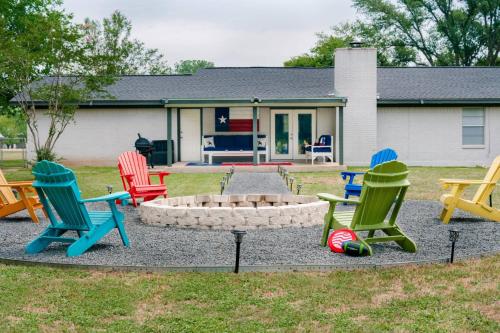 a group of chairs around a fire pit in front of a house at Eclectic Country Home in Leander