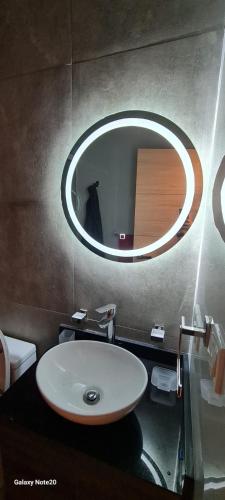 a bathroom with a sink and a large mirror at departamento de 2 dormitorios in La Paz