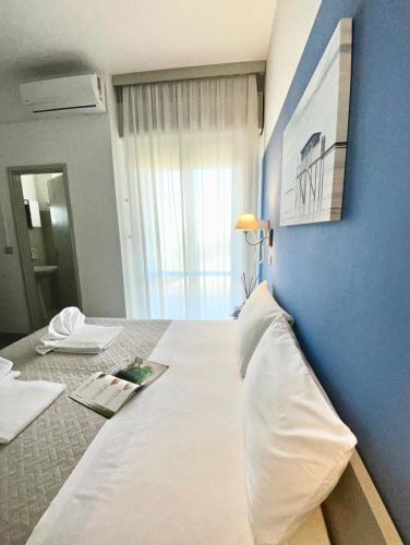 Katil atau katil-katil dalam bilik di Hotel Alfa - SPIAGGIA INCLUSA con pacchetti personalizzati