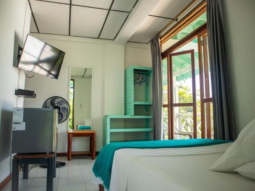 a bedroom with a bed and a window at South West Bay Cabañas in Providencia