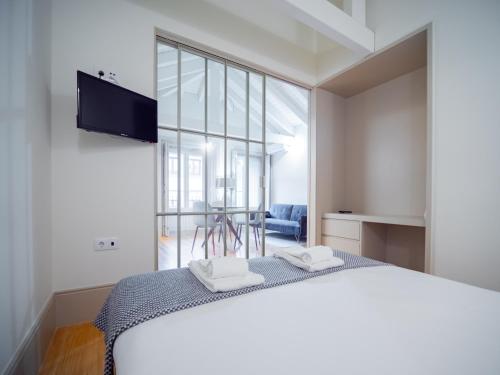 a bedroom with a bed and a large window at OportoCityView - Almada Luxury in Porto