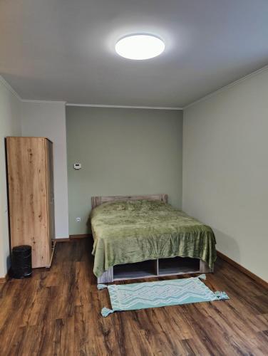 a bedroom with a bed and a wooden floor at Villa Pirken Hammer in Pirkenhammer