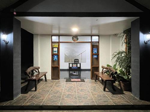 a lobby with two benches and a large window at Batis ni Juan Leisureland in Dipaculao