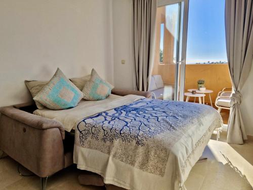 a bedroom with a bed and a balcony with a view at SR Santa Maria Golf Marbella with Sea Views in Marbella