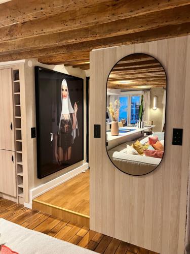 Cette chambre dispose d'une télévision avec une photo d'une femme. dans l'établissement Appartement luxe Louvre Paris, à Paris