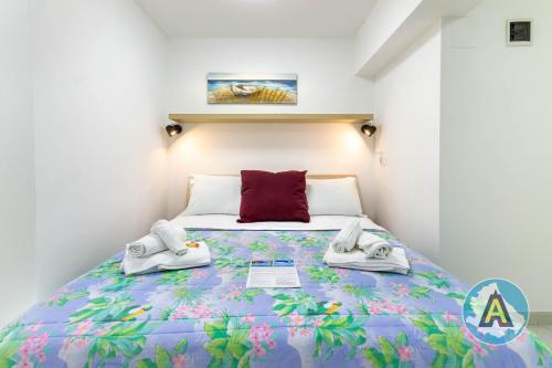 a bedroom with a bed with a colorful bedspread at Casa Arcobaleno 57p in Pescara