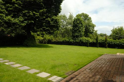 a large grassy yard with a brick driveway at Milo Agriproduction in Milo