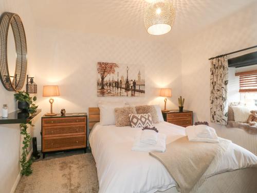 a bedroom with a large bed and a mirror at Flat 2, The Maltings in Oakham
