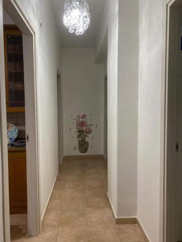 a hallway with a vase of flowers in a room at Casa vacanze paola in Porto Empedocle