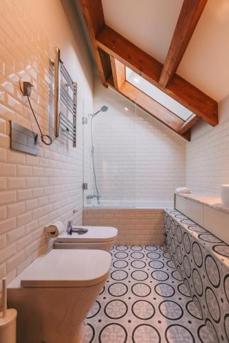 a bathroom with a toilet and a sink at Oporto Maison Palace in Porto