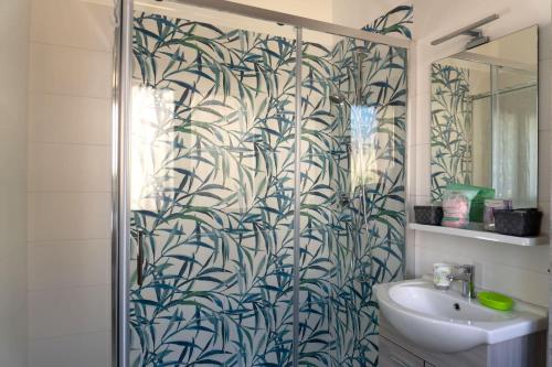 a bathroom with a shower with a mural of bamboo at BnB Martin in Jesolo