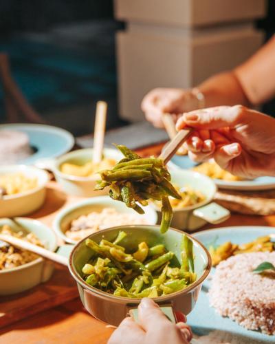 a group of people eating food on a table at The Jungle Loft Galle in Galle