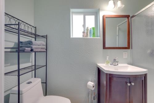 a bathroom with a sink and a toilet and a mirror at Cozy Mesa Vacation Rental with Shared Yard and Hot Tub in Mesa