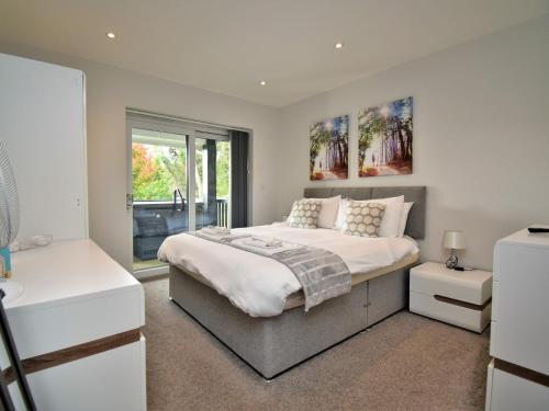 a bedroom with a large bed and a window at 4 Bed in Oswestry 75175 in Kinnerley