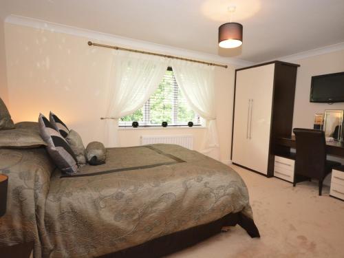 a bedroom with a large bed and a window at 4 Bed in Bideford NILGA in Bideford