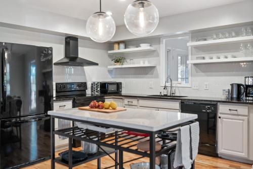 a kitchen with a table with fruit on it at Emerald Cabin W/Hot tub, Firepit, Lake, Skiing in Basye