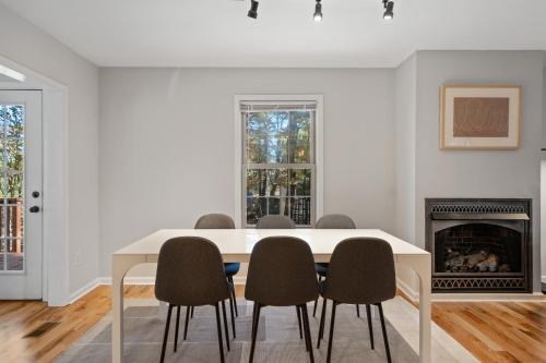 a white dining room with a table and chairs at Emerald Cabin W/Hot tub, Firepit, Lake, Skiing in Basye