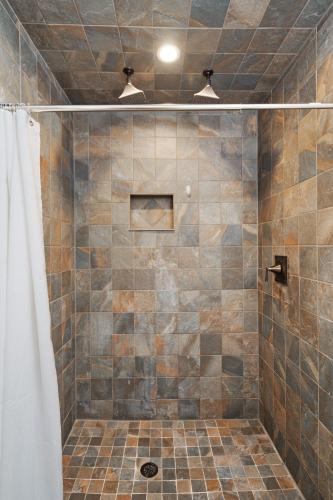 a bathroom with a shower with a tiled shower at Emerald Cabin W/Hot tub, Firepit, Lake, Skiing in Basye