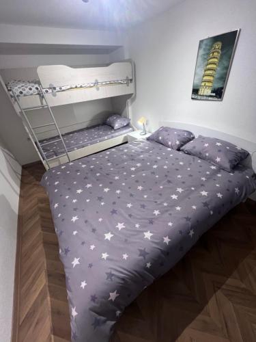 a bedroom with a bunk bed with stars on it at Mavrovo Square One Bedroom APARTMENT in Mavrovo