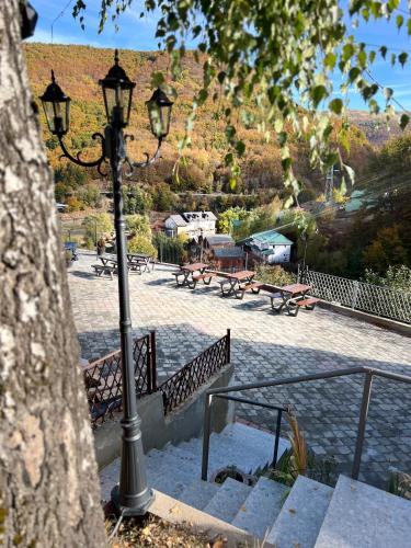 a park with benches and a street light at Mavrovo Square One Bedroom APARTMENT in Mavrovo