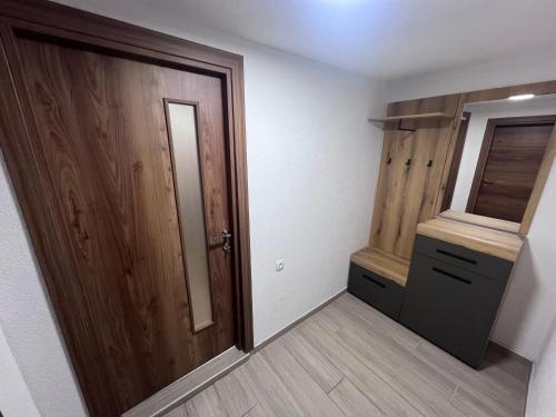 an empty room with a door and a mirror at Mavrovo Square One Bedroom APARTMENT in Mavrovo