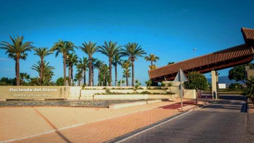 a gas station with palm trees in the background at Casa Martinica 12-1-A , Hacienda del Alamo in Murcia
