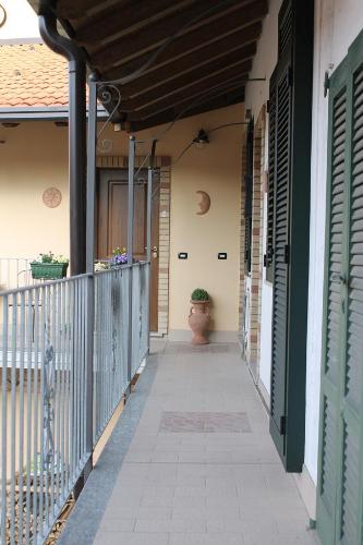 a porch of a house with a vase on it at Le Camere Di Aladino in Carugate
