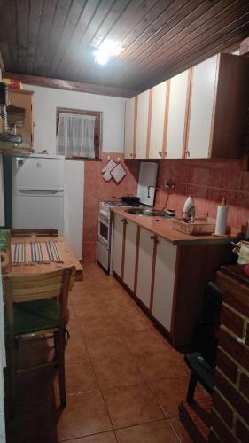 a kitchen with a table and a counter top at Vikendica Mašan in Pale