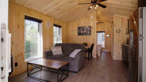 a living room with a couch and a table at Nordique spa Stoneham in Stoneham