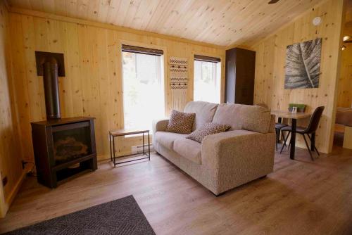 a living room with a couch and a stove at Nordique spa Stoneham in Stoneham