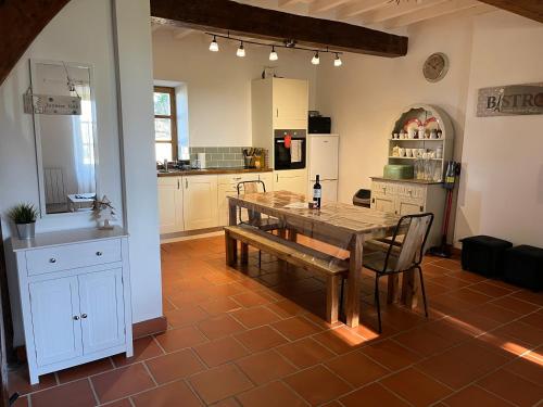 a kitchen with a wooden table and a dining room at Domaine Saladry in Villepinte