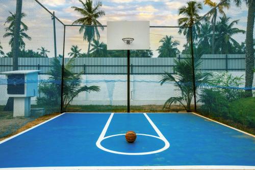 a basketball is sitting on a tennis court at Athulya Resort -Leisure and Luxury cottages from EMBEHolidays in Kottaikadu