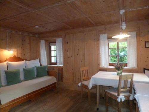 a room with two beds and a table in it at Landhaus Strickenmacher in Sillian